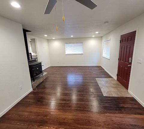 Living Room with Wood Burning Fireplace and Wood Flooring