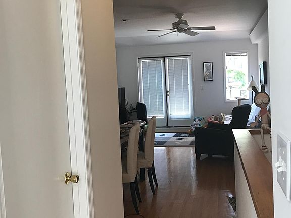 View from the kitchen into the living room. Utility room on the left with washer and dryer.