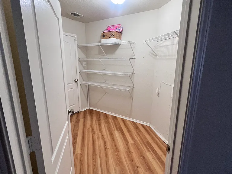 Entry to laundry/pantry/storage room and door out to front garage area from Kitchen
