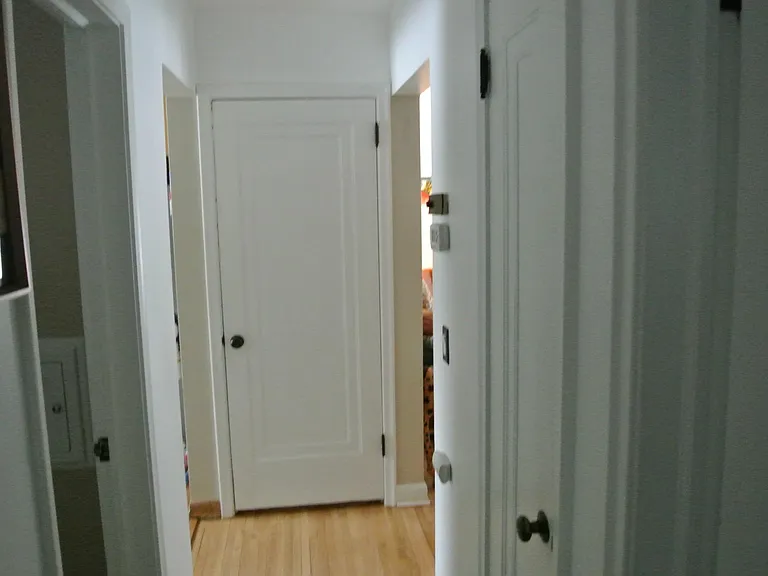 Facing down the hallway facing the living room to the right and kitchen to the left.