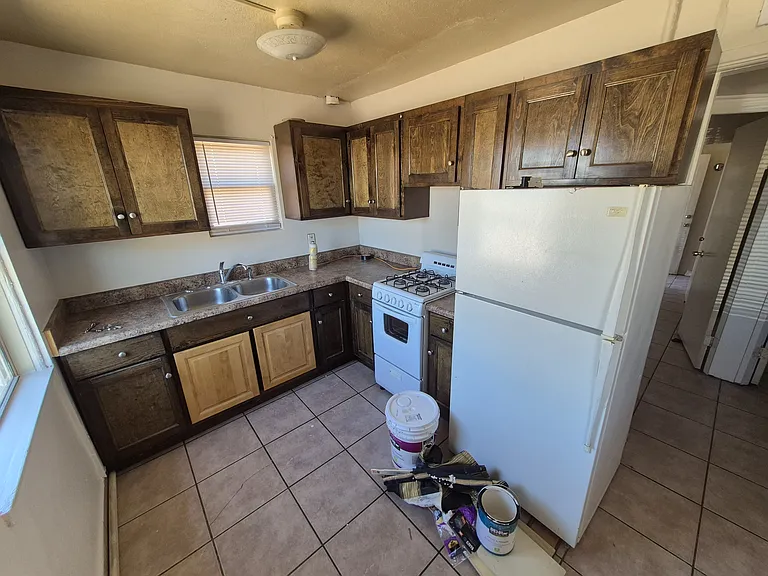 Full size fridge, gas oven and double sink in large kitchen with TONS of storage. Please excuse repair materials as we just finished refreshing the unit.