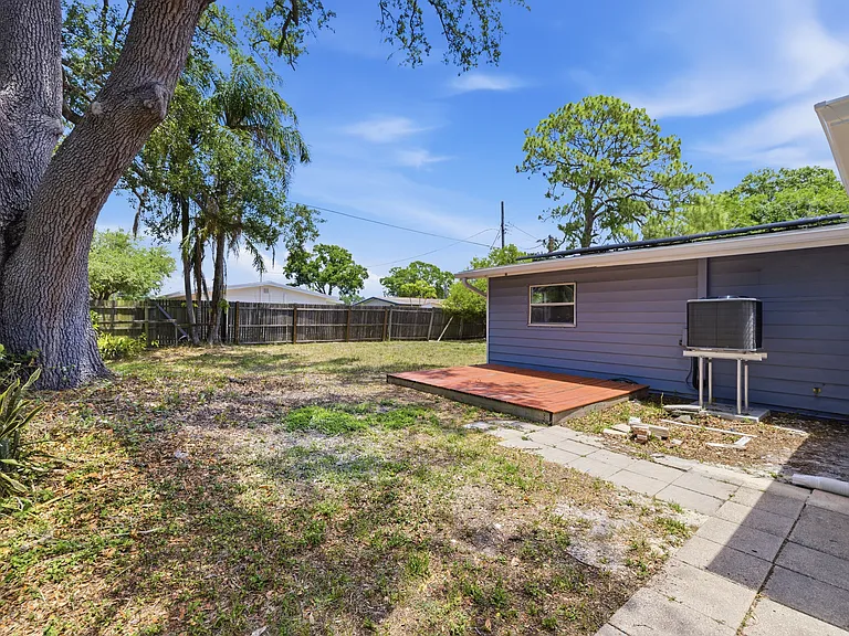 Back entry and yard. Tangerine tree in backyard