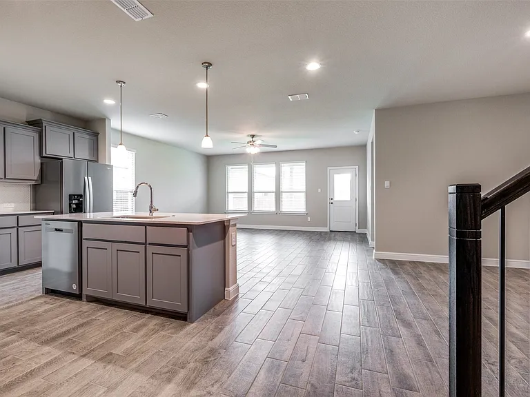 Kitchen featuring sink, a kitchen island with sink, light hardwood / wood-style flooring, and stainless steel appliances