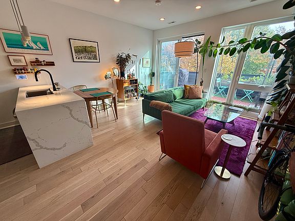 Living room has space to comfortably fit a full-size dining table and more.