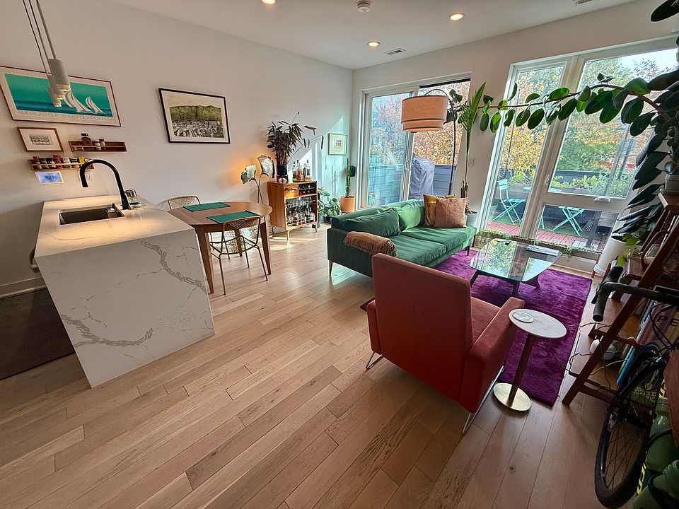 Living room has space to comfortably fit a full-size dining table and more.