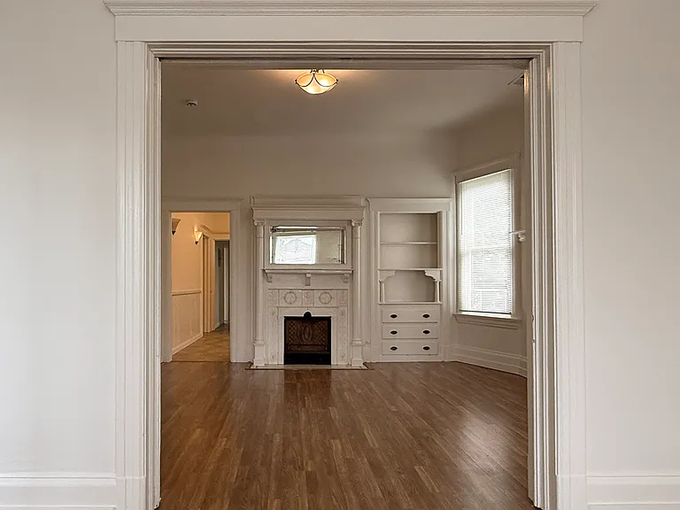 looking from front living room through pocket doors to inner living room
