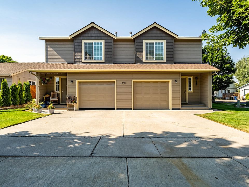 Unit 1 is on the left. Front of home view with flat driveway, 1 car garage and plenty of convenient street parking. Full enclosed fenced yard with irrigation/sprinklers. Landscape maintenance included.