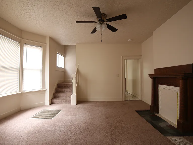 Middle room on first floor. Stairs to second floor on left and doorway to the kitchen on the right.