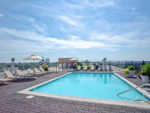 Rooftop pool and sundeck with lounge seating - Avalon at Foxhall
