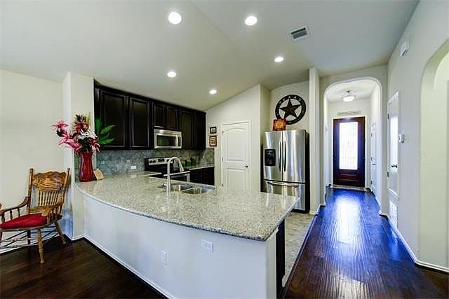 Open living and den with granite top kitchen. New dishwasher