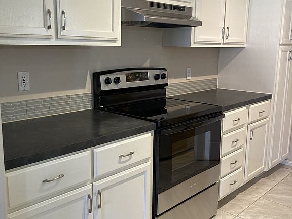 Kitchen with stainless appliances and large pantry