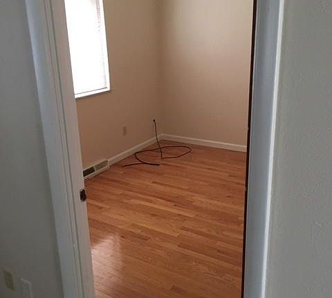 2 bedrooms that have hardwood floors and ceiling fans.