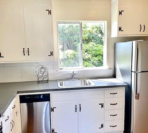 Kitchen has window to back yard and dishwasher