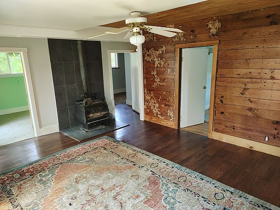 Living room with hardwood floor and antique pine walls