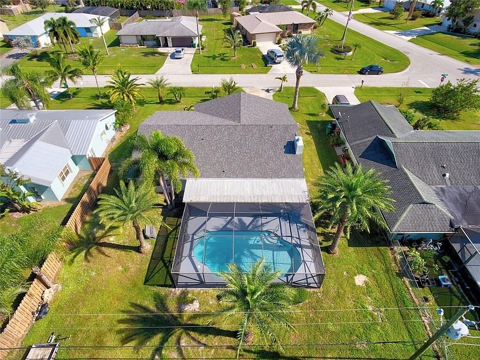 NEW ROOF!   NEWLY REFINISHED POOL!  Amazing Palm Trees so large and mature.