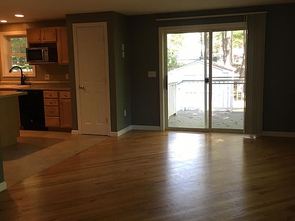 living room facing sliding doors to back deck and yard