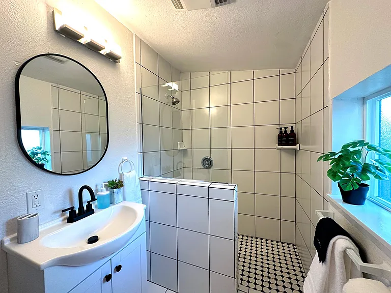 Newly remodeled bathroom fitted with full toiletries and plush bath towels for a spa like retreat