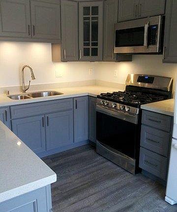New kitchen with convection oven, dishwasher, and refrigerator.