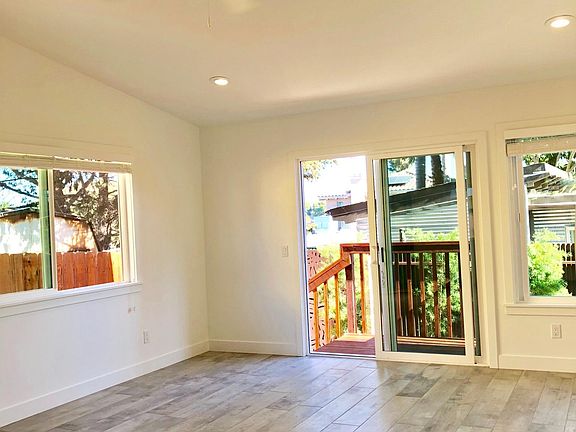 Living room leading to outdoor deck and patio
