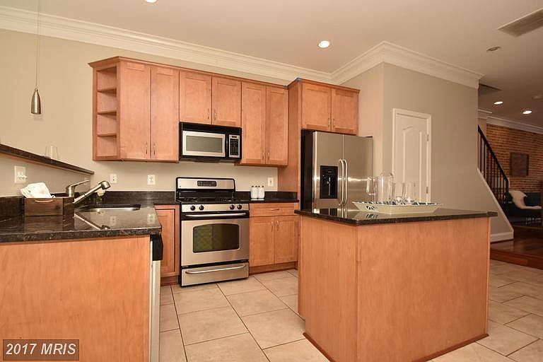 Large kitchen has pantry to the right of the fridge!