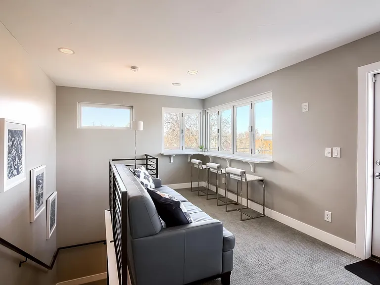 Windows open to outdoor patio and firepit.