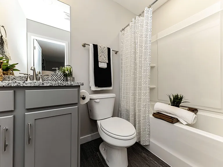 Bright bathroom with granite counters & bathtub