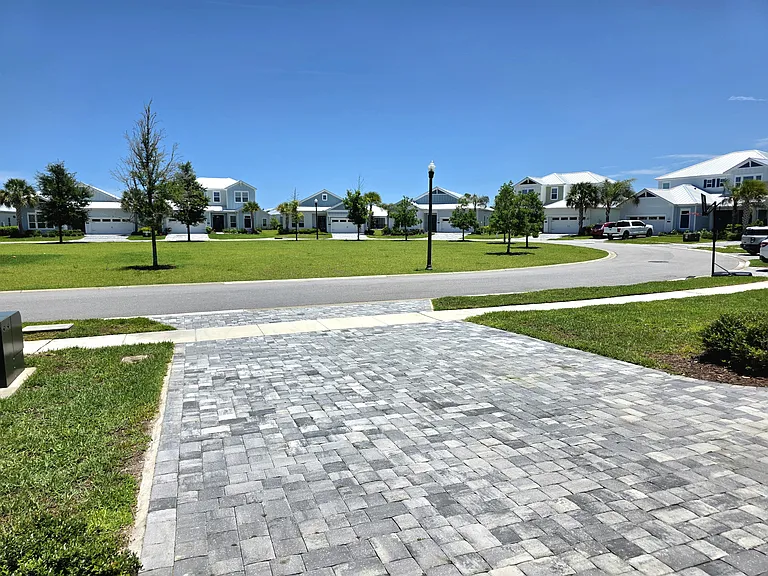 Park-front location on a quiet loop street. Open green space views and minimal through-traffic.