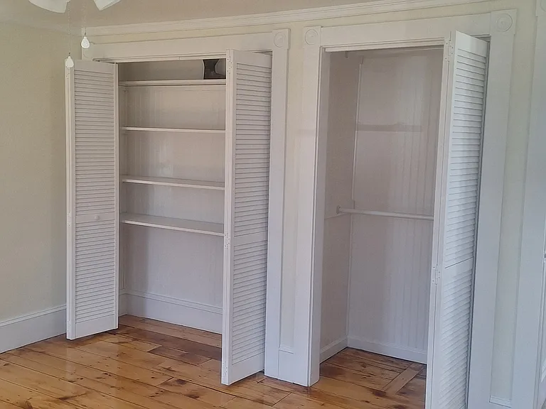 A shelf closet and a double rod hanging closet in the bedroom