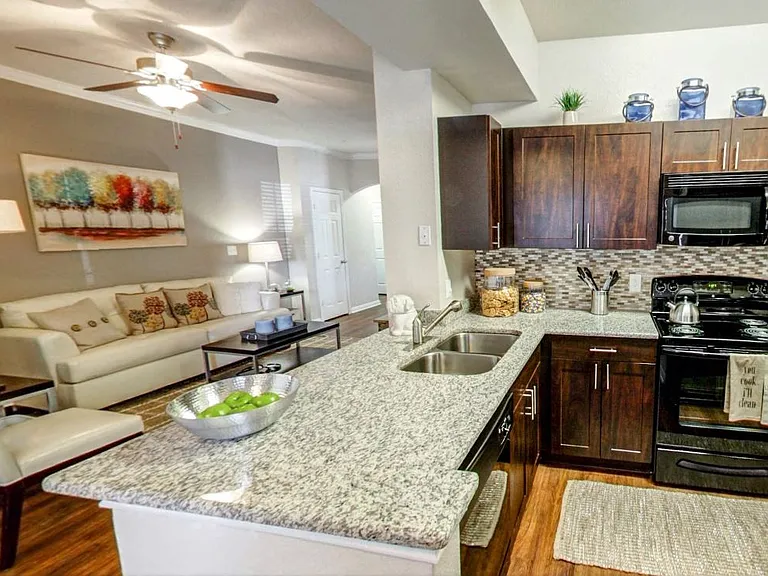 Kitchen with energy efficient appliances and bar overlooking the living room