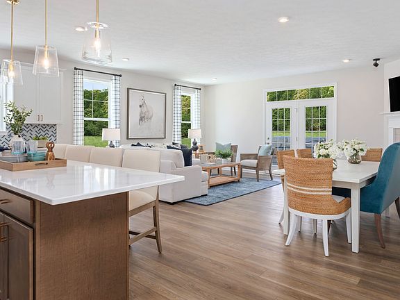 Island kitchen and open main floor in a DRB Homes Finch model at the Grandview Estates community.