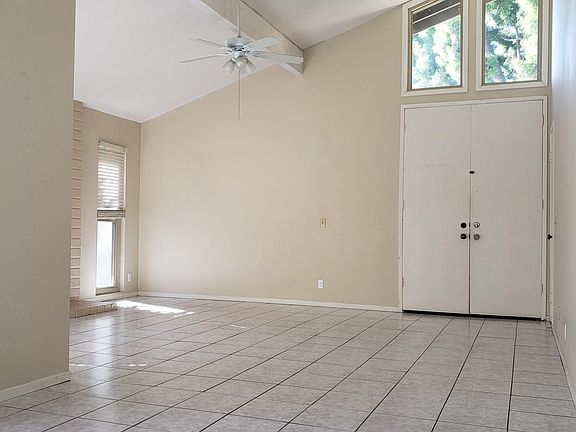Front door and living room space taken from dining room