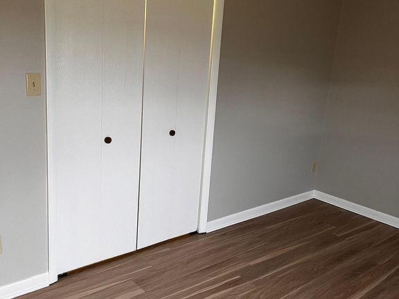 large lighted closet with shelves in the primary bedroom