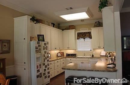 Kitchen
						:
						Adjoins eating area-opens to family room and hall to laundry and master bedroom