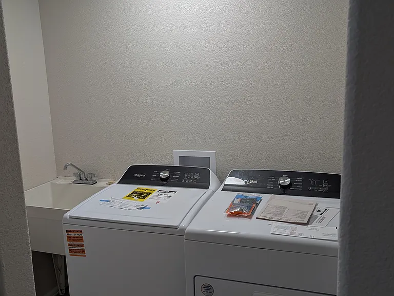brand new washer and dryer and utility sink in your dedicated laundry room