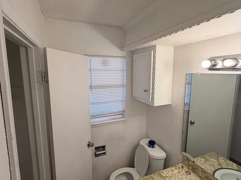 Closet space located in half bathroom, which is located in the master bedroom.