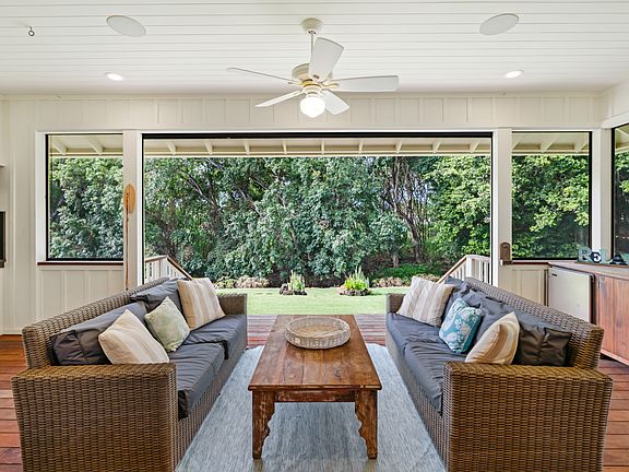 Large Screened in lanai with outside fridge and barbecue overlooking backyard