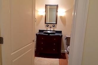 Martha Stewart Furniture repurposed
with vessel to become sink in Powder Room.