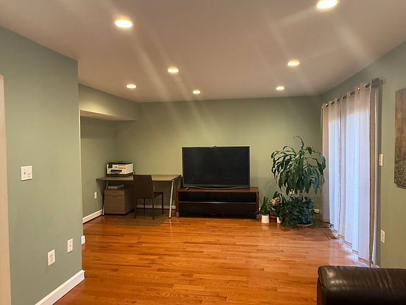 Living room with TV and desk.
