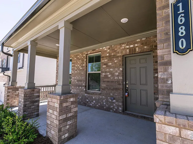 Exterior view of the Wakehurst two-story home featuring a private driveway and attached garage.