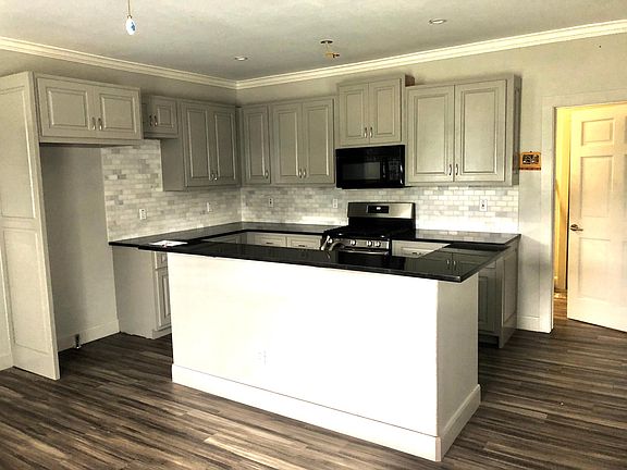 Marble subway tile, custom cabinets, granite counter top, and a gas stove!