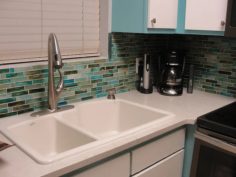 Beach glass tile backsplash with granite countertops! All small appliances and nice upgrades everywhere!