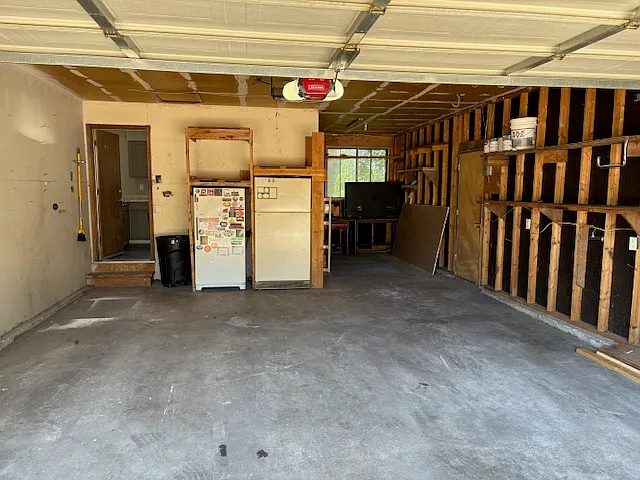 Two car garage with plenty of room for storage or workspace.