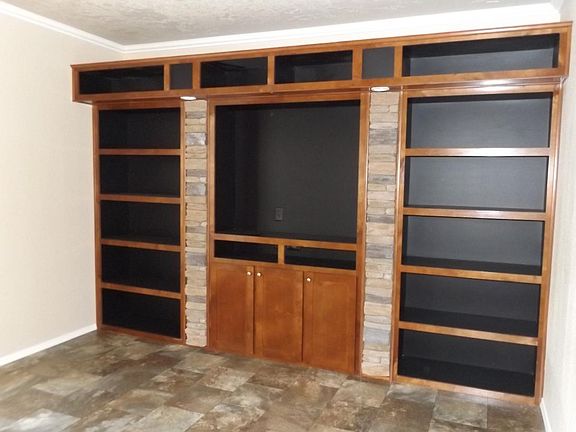 Entertainment area with built in book shelves, recessed ligh