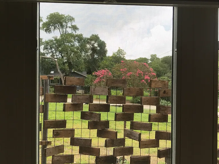 fence to north of apartment & house above