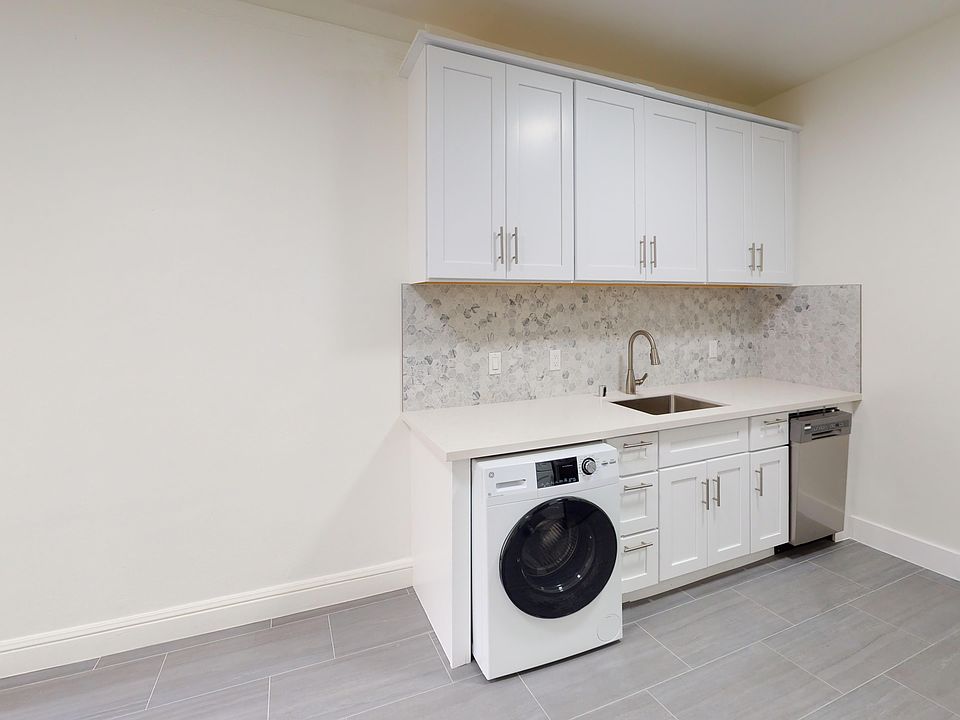 Kitchen with cabinets, sink, and washer