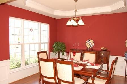 Dining room has trey ceilings and hardwood floors