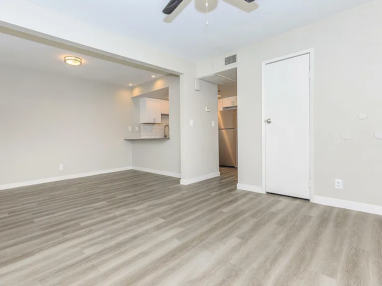 Experience elegance in this spacious open-concept living area, seamlessly connecting to a modern kitchen.