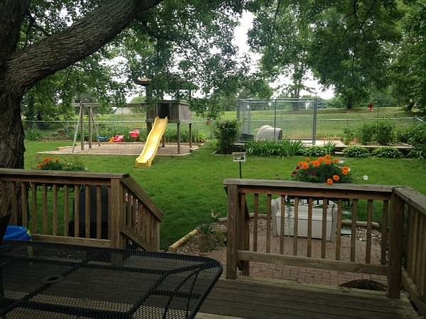 Fenced in Backyard with Playset and Patio