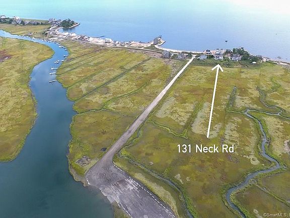 Aerial photo showing the location of 131 Neck Rd in Guilford. The home is located on a peninsula with LI Sound on one side and the East River on the other side. Behind the house more than 50 acres of protected marshes. The unpaved road from Neck Rd to the