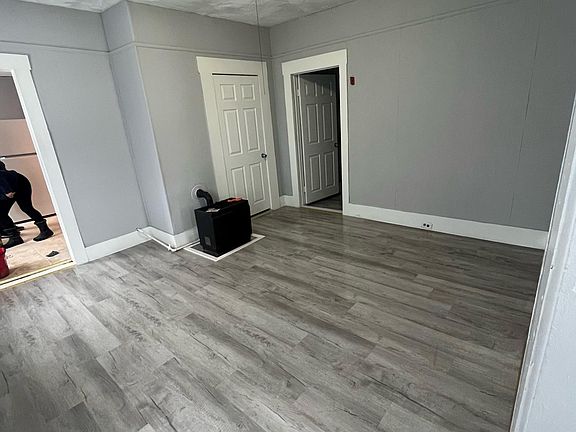 Living room and door to smaller bedroom